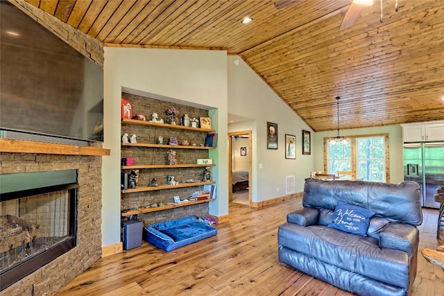 living room featuring a fireplace, wooden ceiling, lofted ceiling, light wood-type flooring, and visible vents
