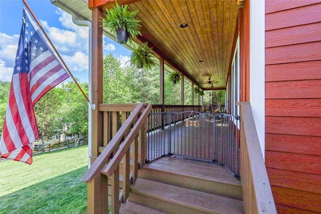 wooden terrace featuring a yard