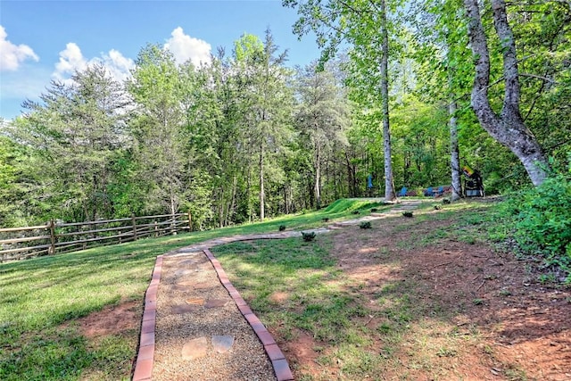 view of yard featuring a view of trees and fence