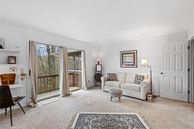 living area featuring baseboards and carpet flooring