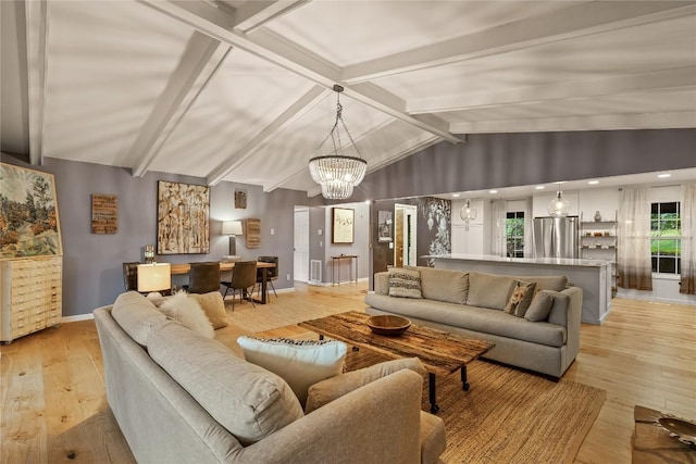 living area with baseboards, vaulted ceiling with beams, a chandelier, and light wood-style floors
