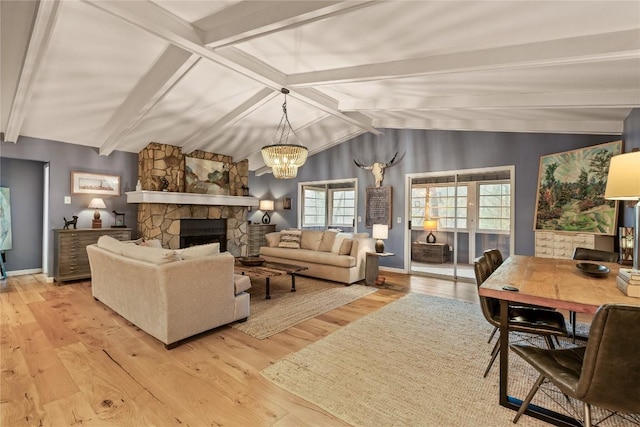 living room featuring baseboards, lofted ceiling with beams, a stone fireplace, a chandelier, and light wood-style floors