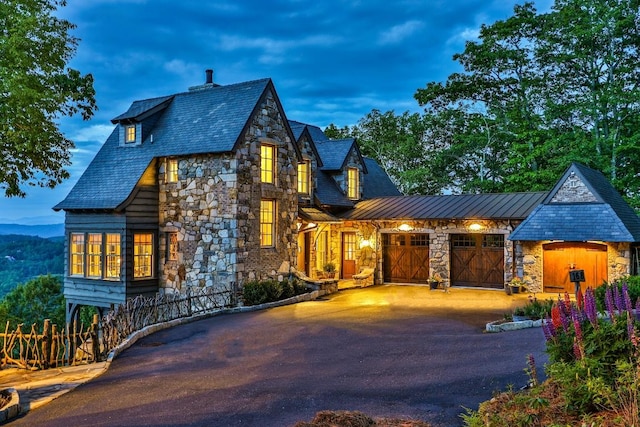 168 Old Wagon Rd, Highlands, NC 28741 - view of front of house featuring stone siding, driveway, an attached garage, and a high end roof