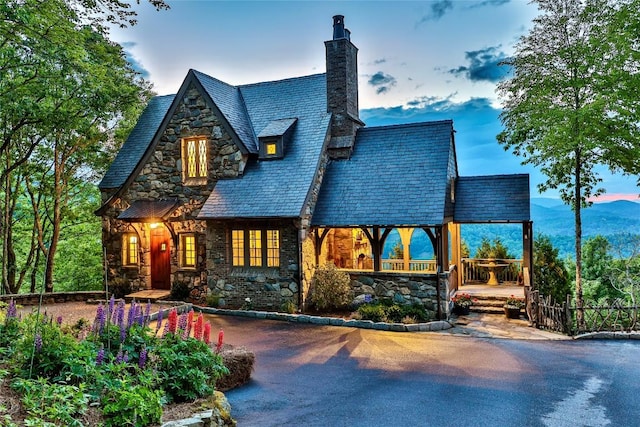 168 Old Wagon Rd, Highlands, NC 28741 - rear view of house featuring a high end roof, a chimney, and stone siding