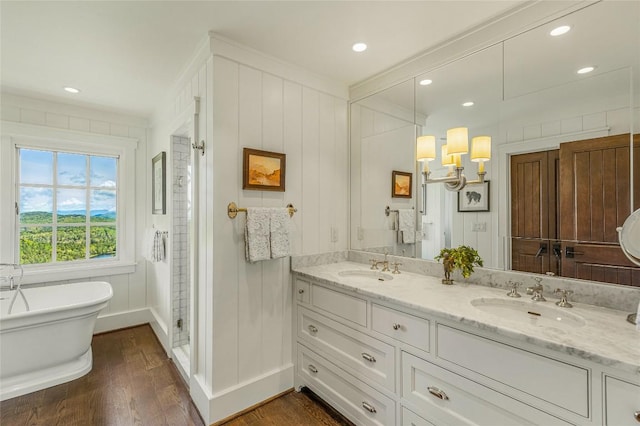 168 Old Wagon Rd, Highlands, NC 28741 - bathroom featuring wood finished floors, double vanity, a freestanding bath, ornamental molding, and a stall shower