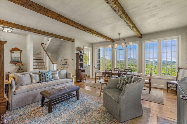 168 Old Wagon Rd, Highlands, NC 28741 - living area featuring wood-type flooring, baseboards, a chandelier, beam ceiling, and stairway