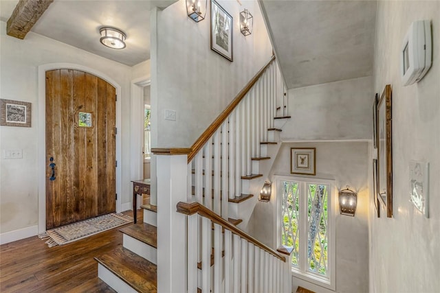 168 Old Wagon Rd, Highlands, NC 28741 - foyer with hardwood / wood-style flooring, stairway, arched walkways, and baseboards
