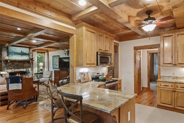 161 Kestrel Ct, Sapphire, NC 28774 - kitchen with appliances with stainless steel finishes, a wood ceiling with exposed beams, light wood-type flooring, light stone counters, and coffered ceiling