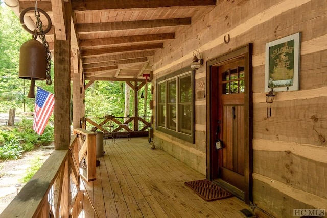 wooden terrace featuring covered porch