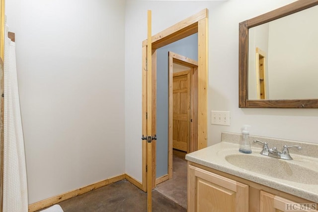 bathroom featuring unfinished concrete floors and vanity