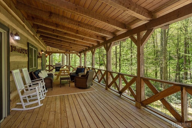 deck featuring an outdoor living space and a forest view