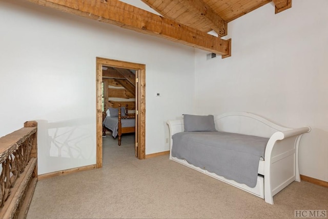 carpeted bedroom featuring wood ceiling, beamed ceiling, and baseboards