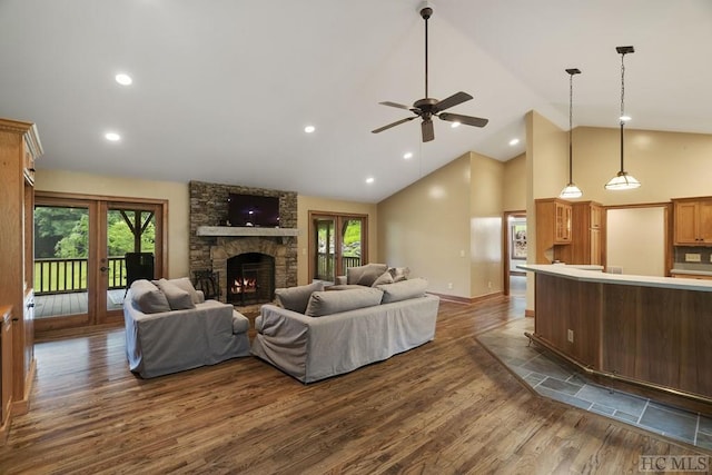 living room featuring a healthy amount of sunlight, french doors, high vaulted ceiling, and dark hardwood / wood-style flooring