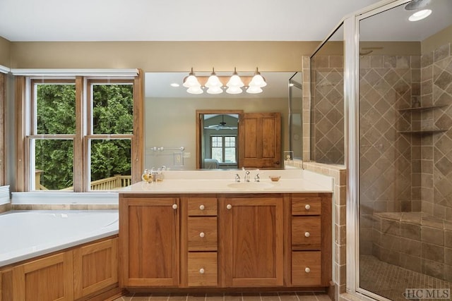 bathroom with plus walk in shower, vanity, and plenty of natural light