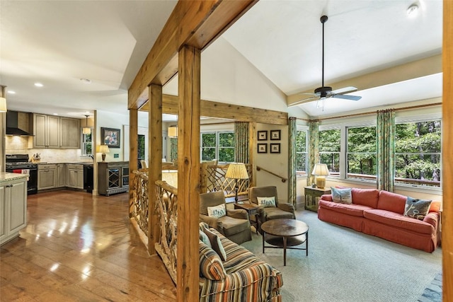 living room featuring high vaulted ceiling, beamed ceiling, light hardwood / wood-style floors, and ceiling fan