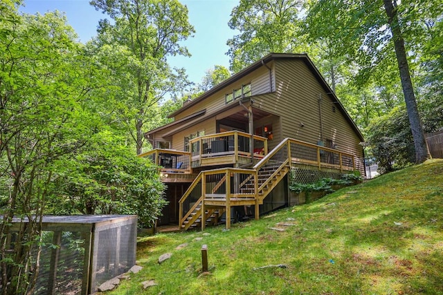 rear view of house with a yard and a deck