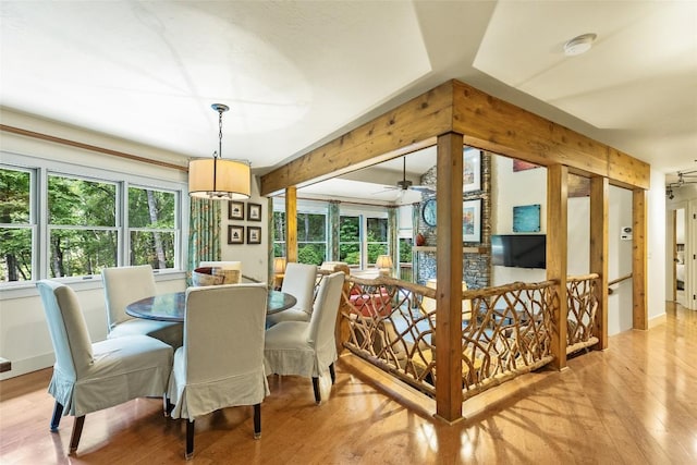 dining space featuring beam ceiling and light hardwood / wood-style floors