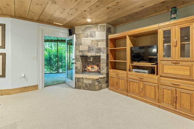 carpeted living room featuring a fireplace and wooden ceiling