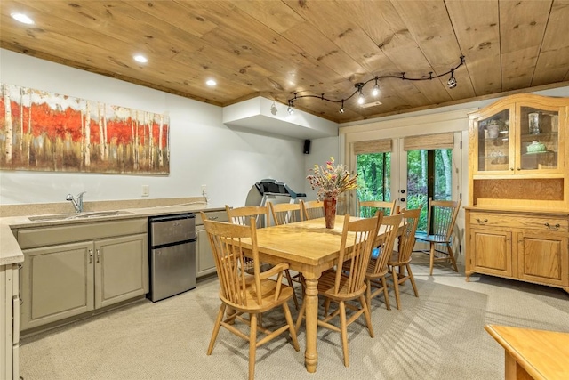 carpeted dining room featuring sink, track lighting, wooden ceiling, and french doors