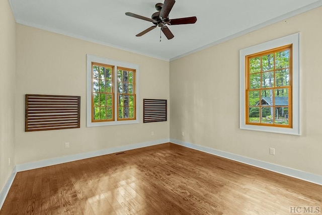 spare room with wood-type flooring and ceiling fan