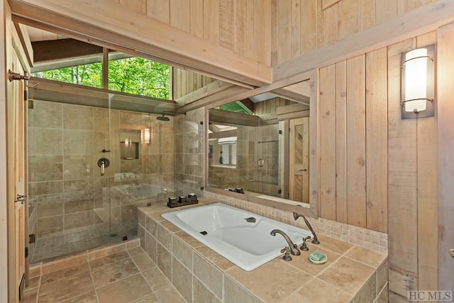 bathroom with separate shower and tub, tile patterned floors, and wooden walls