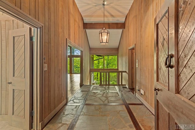 entryway featuring vaulted ceiling with beams, wood ceiling, and wood walls