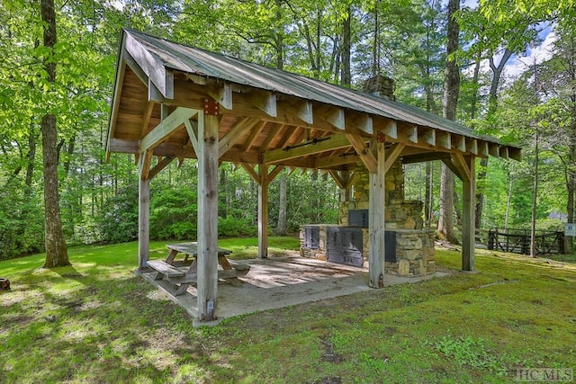 view of property's community with a gazebo, a patio, and a lawn