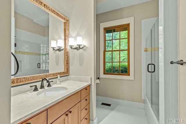 bathroom with vanity, tile patterned flooring, and a shower with door