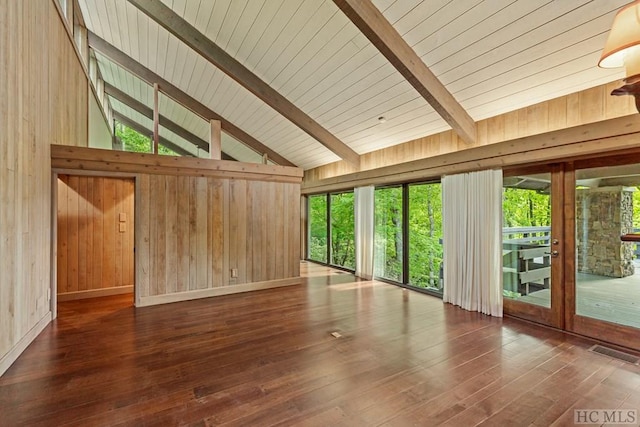 unfurnished sunroom featuring lofted ceiling with beams