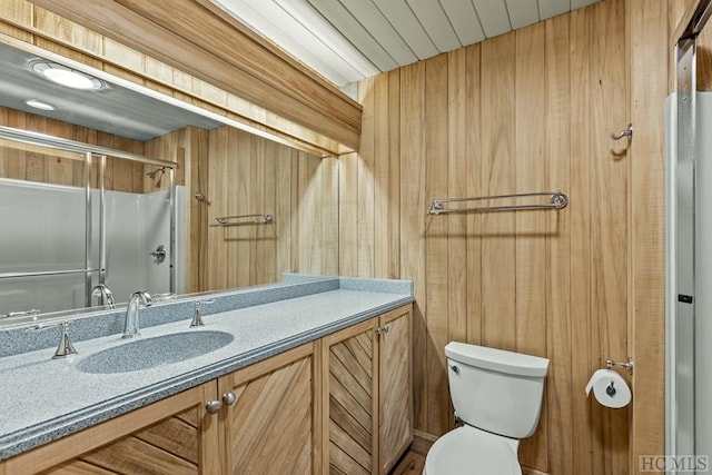 bathroom featuring vanity, toilet, and a shower