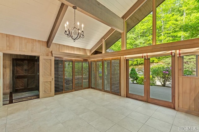 unfurnished sunroom with a notable chandelier and vaulted ceiling with beams