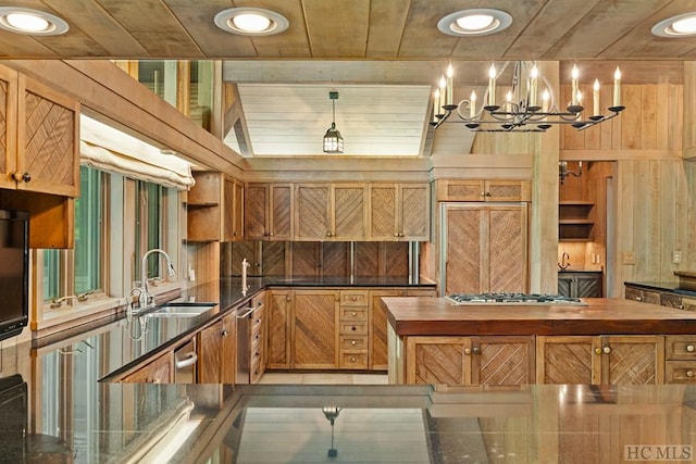 kitchen featuring sink, wood ceiling, an inviting chandelier, stainless steel gas cooktop, and decorative light fixtures