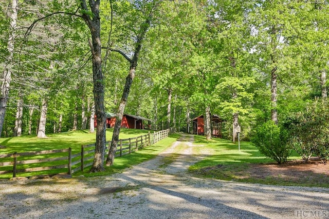 view of property's community with an outdoor structure and a yard