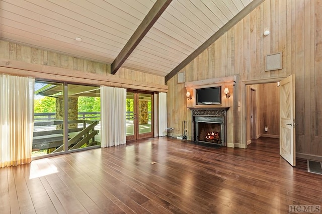 unfurnished living room featuring wooden walls, high vaulted ceiling, dark hardwood / wood-style floors, and beamed ceiling