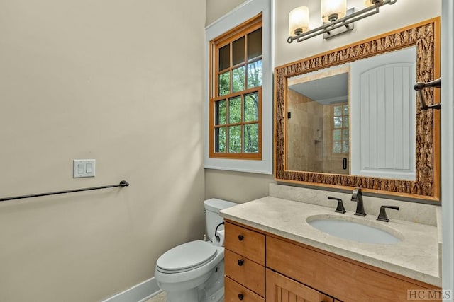 bathroom featuring walk in shower, vanity, and toilet