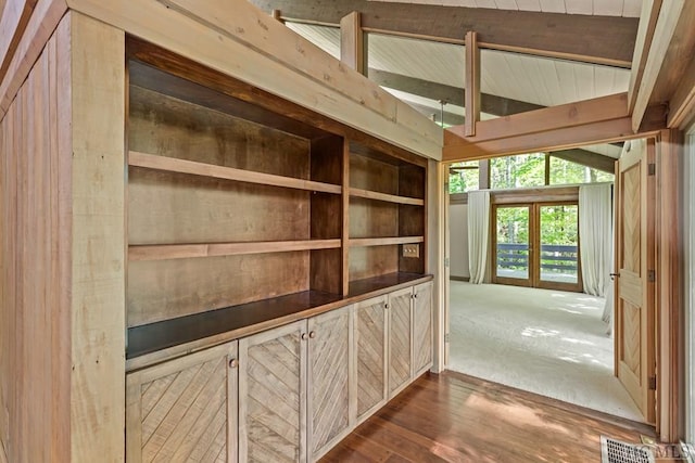 interior space with vaulted ceiling and dark wood-type flooring