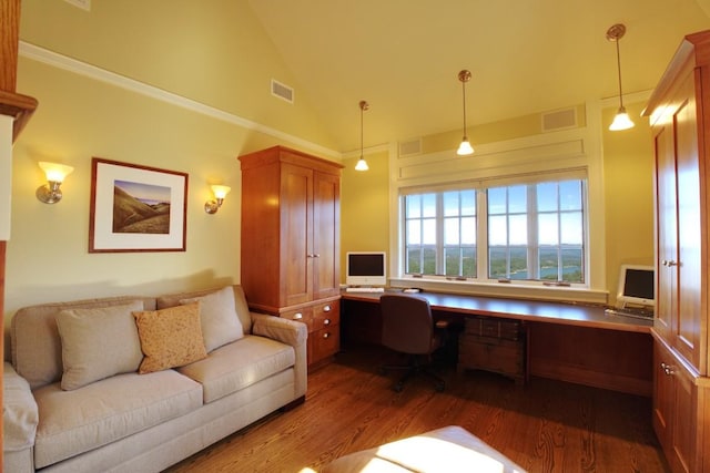 office area featuring built in study area, high vaulted ceiling, wood finished floors, and visible vents