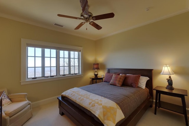 carpeted bedroom with a ceiling fan, baseboards, visible vents, and crown molding