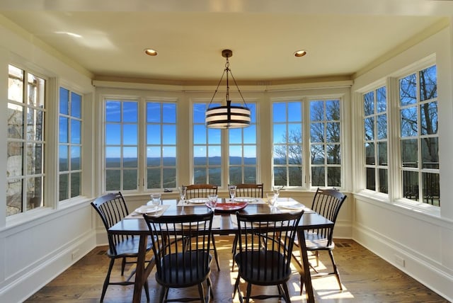 sunroom featuring recessed lighting, wood finished floors, and plenty of natural light