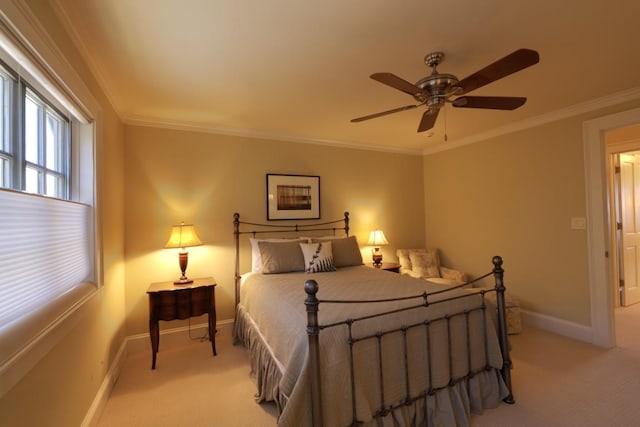 bedroom with light carpet, ceiling fan, baseboards, and crown molding