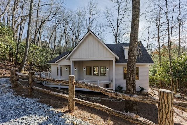 view of front of house featuring covered porch and roof with shingles