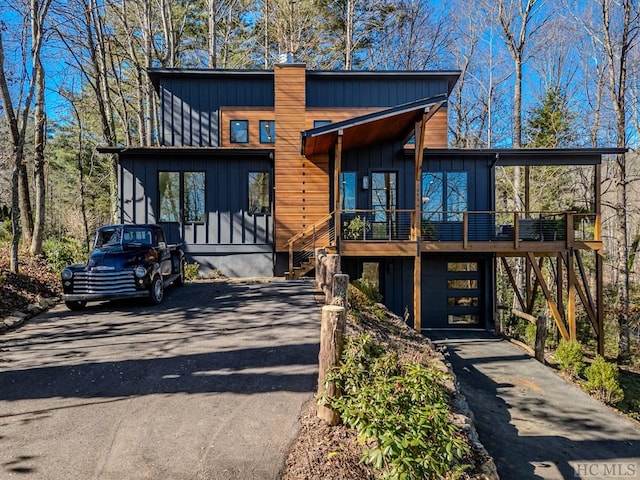 modern home featuring a garage and a deck