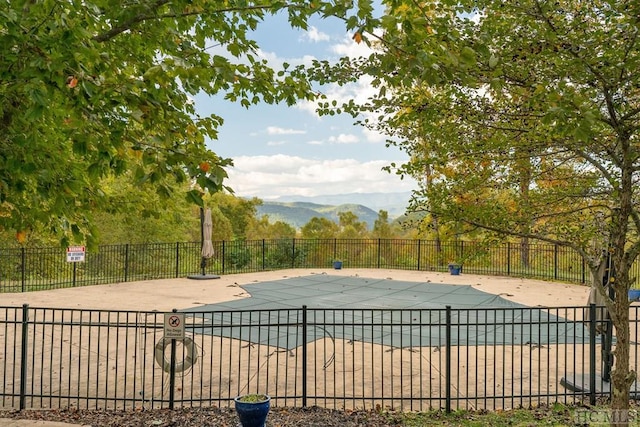 view of pool with a mountain view and a patio area