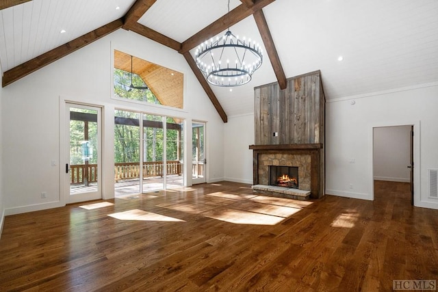 unfurnished living room featuring beam ceiling, a stone fireplace, high vaulted ceiling, a chandelier, and dark hardwood / wood-style flooring