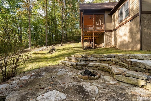 view of yard featuring a patio and an outdoor fire pit