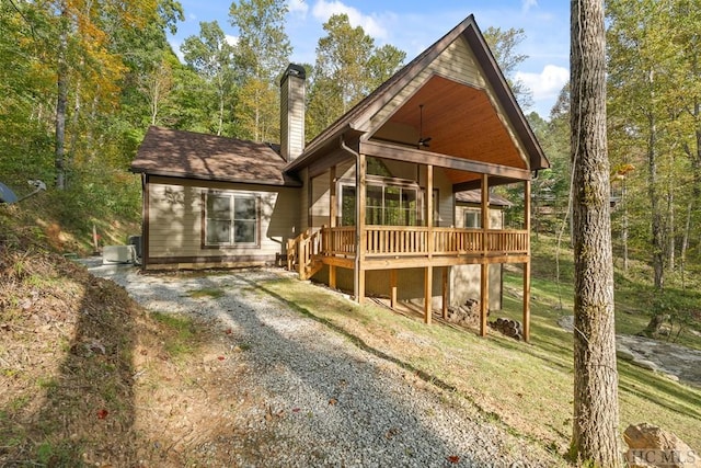 back of house featuring central AC unit and a wooden deck