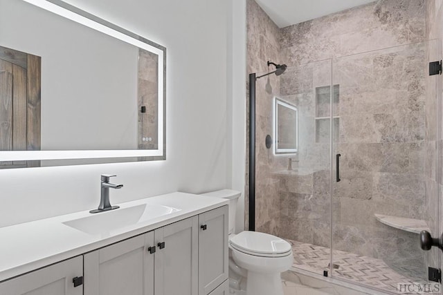 bathroom featuring vanity, toilet, and walk in shower