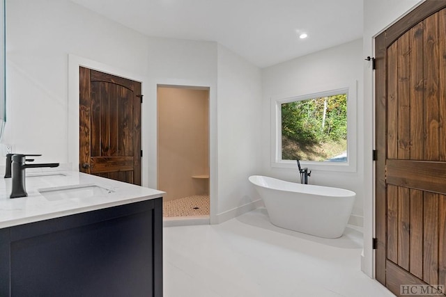 bathroom featuring vanity and plus walk in shower