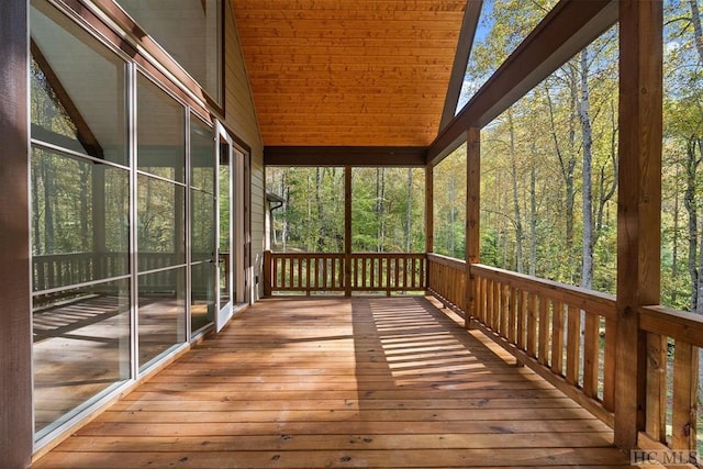 unfurnished sunroom featuring vaulted ceiling