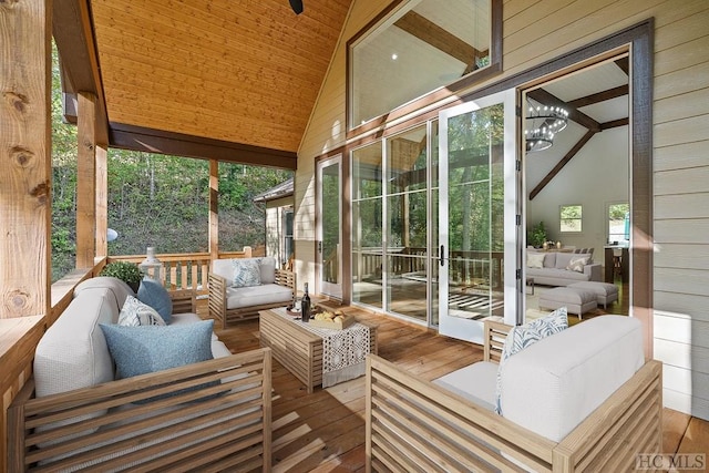 sunroom featuring lofted ceiling, wooden ceiling, and a notable chandelier